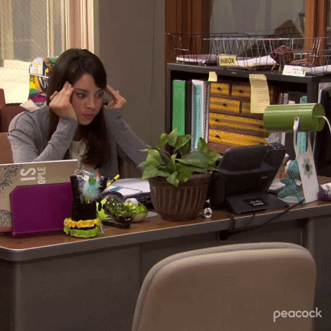 April Ludgate in Parks and Recreation putting her fingers to her forehead and looking exasperated and overwhelmed'